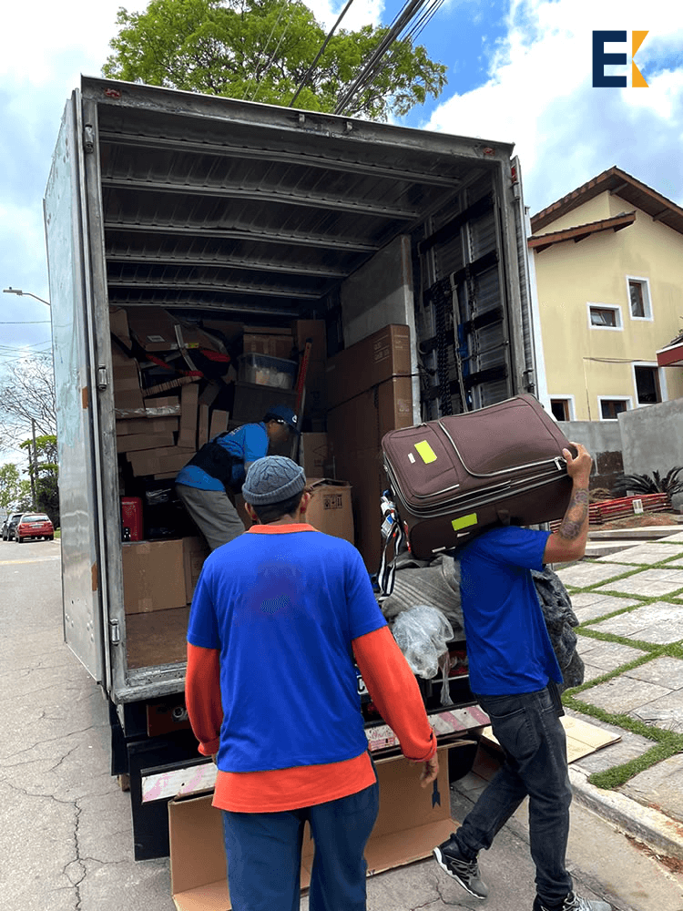Equipe descarregando caminhão de mudança.